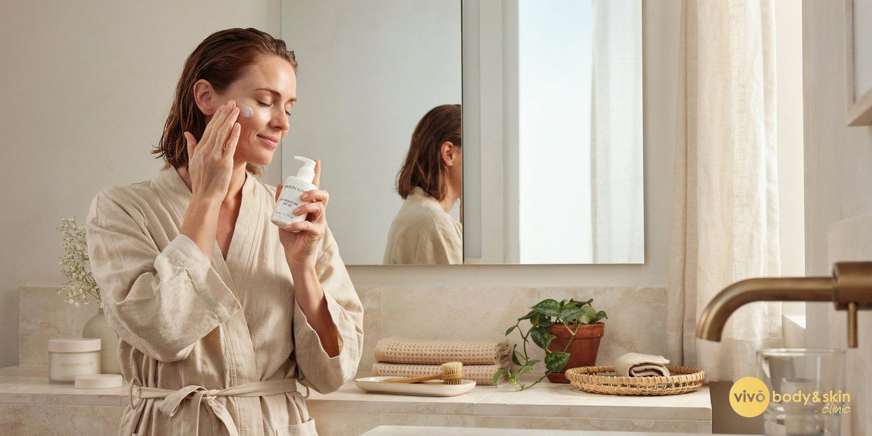 Woman applying skincare and sun protection as part of a skin firming routine